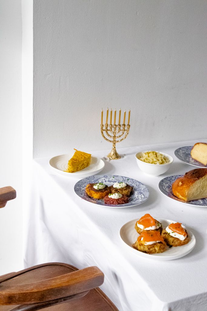 A festive table set with traditional Jewish dishes for Hanukkah celebration.