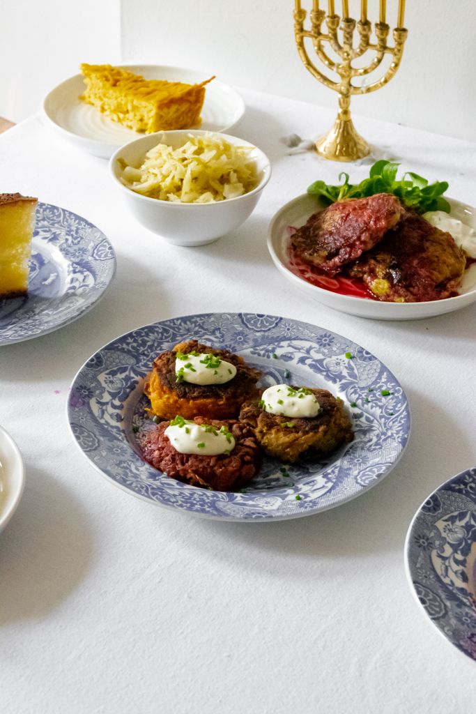 A traditional Jewish meal set up for Hanukkah with various dishes and a menorah.